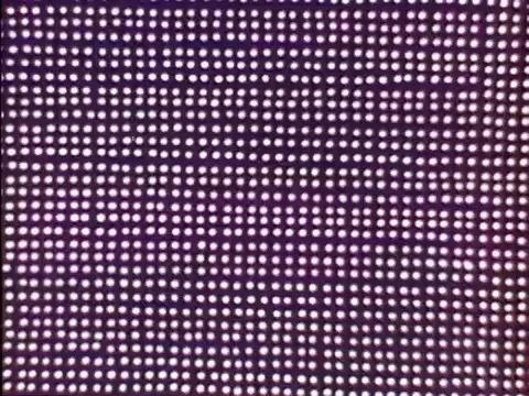 The still features a pattern of brightly lit dots against a purple background, characteristic of the vibrant visual style of the 'Rocky and Bullwinkle' show titles. This 16mm print captures the playful and animated aesthetic typical of the credits.   For more film insights, subscribe, like, or follow us on Twitter @FromFilm!