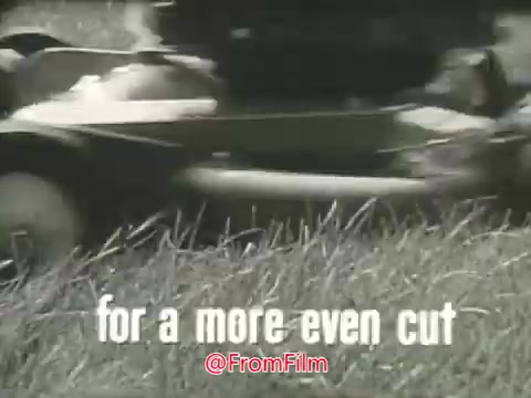 The still features a close-up of a Toro Whirlwind Lawnmower in action, cutting through tall grass. Accompanying the image is the text 'for a more even cut,' emphasizing the product's effectiveness. The visual captures the nostalgia of 1960s advertising with a focus on lawn care. The graininess from the 16mm print adds an authentic vintage feel to the commercial.