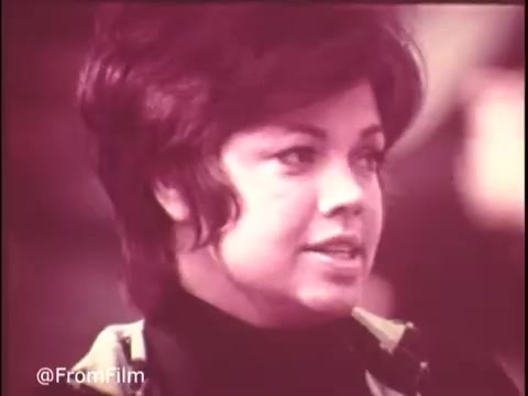 This still from the 1970s Colgate Pruf Spray Starch features a woman with a stylish, voluminous hairstyle, indicative of the era. She appears engaged and expressive, possibly promoting the product. The visual quality reflects the unique characteristics of 16mm film, with a soft color palette typical of the time. The overall vibe embodies the fashion and culture of the 1970s.   Follow us on Twitter @FromFilm.