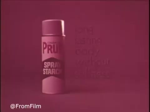 The still features a sleek, cylindrical can of Colgate Pruf Spray Starch, prominently displaying the brand name. The background is a solid pink hue, creating a vibrant contrast with the can. Text in a slightly lighter shade emphasizes the product's benefits, suggesting it offers body without stiffness. The overall aesthetic captures the colorful and bold style typical of 1970s advertising.   Follow us on Twitter @FromFilm.