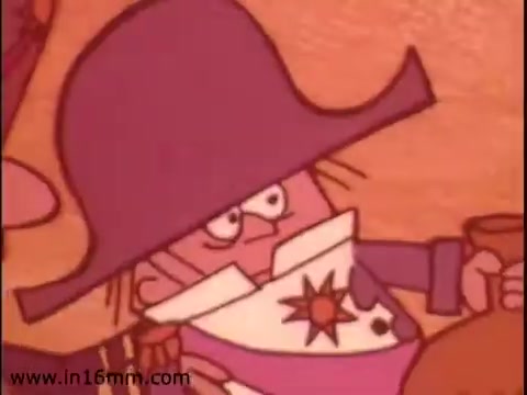 The still from 'Klik and Kam Lunch Meat,' a 1970s animated commercial, features a character with a large cowboy hat and exaggerated facial features. The character is dressed in a colorful outfit with a star decoration on the chest, suggesting a whimsical and humorous tone typical of that era's animation style. The background hints at a playful, cartoonish setting. The commercial promotes Klik, highlighting its place among Canadian lunch meat products.