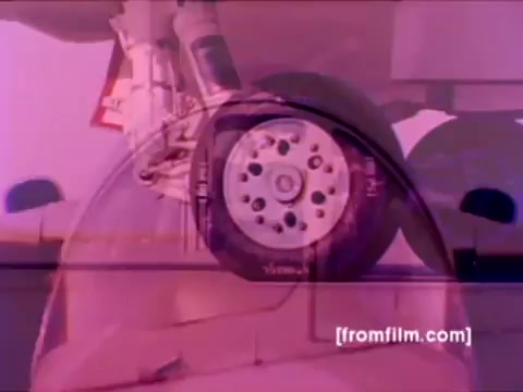 The still from the 'USMC Aviation Ordnance enlistment film' captures a close-up view of an aircraft wheel, likely from a military jet. The image has a vintage aesthetic typical of 16mm film, showcasing vibrant colors that have been slightly deteriorated. In the context of the film, it highlights the maintenance and support aspect of aviation ordnance, tying into the overall theme of enlisting in the Marine Corps. The emphasis on the wheel suggests a focus on the readiness and operational capability of aircraft such as F-4 Phantoms, AH-1 SuperCobras, and FA-18s, reinforcing the role of ordnance personnel in ensuring that these machines are flight-ready.