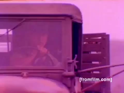 The still from the 'USMC Aviation Ordnance' enlistment film showcases military aircraft, including F-4 Phantoms, AH-1 SuperCobras, an FA-18, and a Harrier. It depicts the process of mounting ordnance, such as missiles and bombs, emphasizing the technical and operational roles within the Marine Corps. The 16mm negative is characterized by a muted color palette; color correction would enhance the visual clarity and vibrancy, providing a more dynamic representation of the military activities.