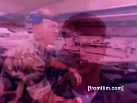 The still from the 'USMC Aviation Ordnance enlistment film' depicts scenes featuring various military aircraft, including F-4 Phantoms, AH-1 SuperCobras, FA-18s, and Harriers. The focus of the imagery is on ordnance operations, showing Marines expertly mounting missiles and bombs onto these aircraft. The color appears muted due to the film's 16mm origin, which may necessitate correction for improved visibility and detail. The overall atmosphere conveys a sense of precision and professionalism in military preparation.