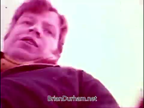 The still appears to capture a moment from 'Campbell's Soup - The Manhandlers,' featuring a character in a close-up shot. The scene seems to convey a casual or humorous tone. The color palette suggests a nostalgic or vintage feel, typical of 16mm film. Frankie Laine's theme song likely adds a playful or lively ambiance to the overall context.