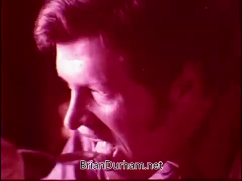 The still from 'Campbell's Soup - The Manhandlers' features a man enjoying a bowl of soup, with a focus on his expressive face as he takes a spoonful. The red-toned lighting adds a warm and inviting atmosphere, highlighting the comforting nature of the soup. This scene connects with the theme song by Frankie Laine, enhancing the nostalgic and wholesome appeal of the product.