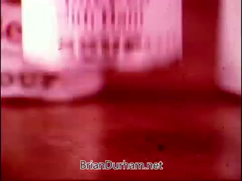 The still likely features a focused shot of Campbell's Soup cans, possibly in a casual or playful arrangement, reflecting the theme of the commercial. The vibrant colors and vintage aesthetic suggest a 1960s or 70s style, aligning with Frankie Laine's upbeat theme song. The overall context hints at a light-hearted portrayal of food, combining humor and nostalgia.