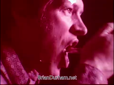 The still from 'Campbell's Soup - The Manhandlers,' featuring Frankie Laine, likely captures an intense moment during a performance. The lighting and focused expression suggest a dramatic or energetic scene, with Laine possibly singing or engaging directly with the audience. The rich color tones add a vintage feel, typical of 16mm film, enhancing the atmosphere of the performance.