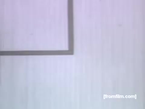 The still from the 1950s UPA Post Grape-Nuts Flakes commercial features a simple, stylized animation aesthetic typical of the era. It showcases a minimalist background with a box or outline, likely representing the product packaging or a visual element related to the commercial’s theme. The overall color palette and design reflect the vintage animation style prominent in UPA's works.