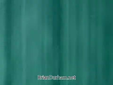 The still from the 1960's Veterans Day PSA features a simple, solid background, likely in a teal or green hue. The image conveys a sense of solemnity or reflection, typical of public service announcements aimed at honoring veterans. The visual is minimalistic, focusing on the message rather than any specific imagery.