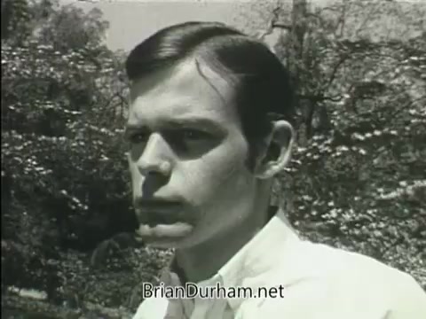 The still features a young man with a serious expression, set against a backdrop of trees and greenery. The image, from a 1968 PSA about the Junior GI Bill, captures the essence of youth and concern, likely reflecting themes of education and opportunity. The style is typical of the era, emphasizing a straightforward and earnest tone.