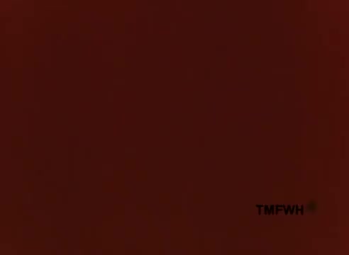 The still features a deep red background, likely serving as a color block for the vintage commercial. The text 'TMFWH' appears in the corner, possibly indicating a watermark or production company. The overall aesthetic is characteristic of 1970s advertising, evoking a sense of nostalgia for quirky and whimsical marketing approaches of the time.