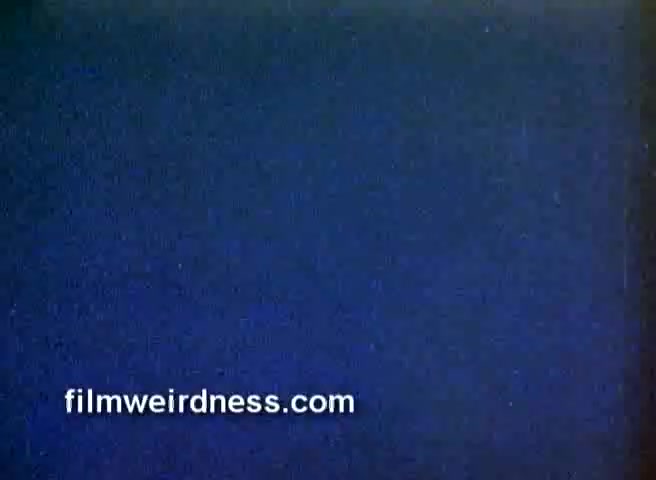 The still from the 16mm negative appears to show a blank or static frame with a blue background, likely indicating a transition between segments of the film. It represents a snippet from a commercial for Barney's New York followed by a partial CBS Christmas story. The focus on a blank frame suggests a moment of pause or separation in the original footage.