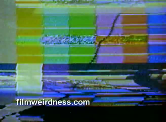 The still you provided appears to be a frame from a 16mm film negative experiencing distortion or visual glitches. The image features vibrant, disrupted colors with horizontal and vertical lines, suggesting a technical issue with the film or projection. This may relate to the audio issues often encountered with older media formats. The context refers to a commercial for Barney's NY from 1970, followed by a partial CBS Christmas story.