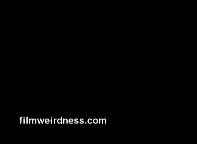 The still appears to be a black screen featuring a watermark from 'filmweirdness.com.' It suggests that the content is related to film history or analysis, specifically referencing a 16mm negative of a commercial for Barney's NY from 1970, followed by a partial CBS Christmas story. The visual information is absent, indicating it may be a placeholder or context setting for the actual film material being discussed.