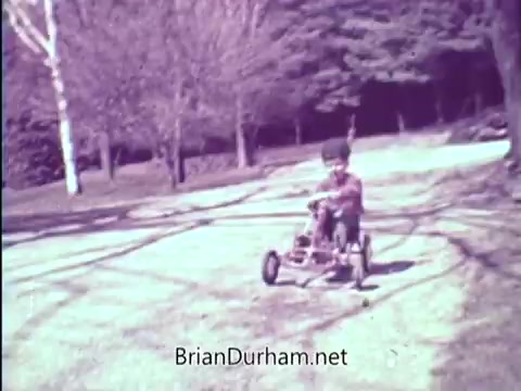 The still depicts a young child riding a small go-kart on a pathway, surrounded by trees. The setting appears to be a sunny day, evoking a sense of innocence and play. This image aligns with the voiceover's message about the importance of vision, particularly addressing the issue of Amblyopia (lazy eye) and the need for early detection and treatment to prevent blindness in children.