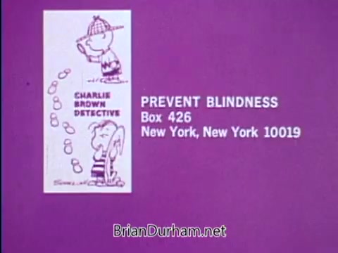 The still from the 'Prevent Blindness PSA - 1967' features a purple background with a promotional graphic that includes characters resembling Charlie Brown and a friend. The text highlights the organization 'Prevent Blindness' and provides a mailing address in New York City. The visual aims to raise awareness about amblyopia, or lazy eye, emphasizing the importance of early detection and treatment to maintain good vision in children.