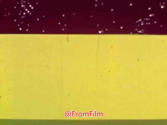 The still from 'Coffee Break' likely features a colorful, animated style typical of mid-20th century advertising. The vibrant background—possibly featuring yellow and maroon colors—combined with abstract elements suggests a playful, whimsical approach. It may be promoting a product or idea related to coffee or relaxation, fitting the theme of a coffee break. The specific details of the animation and any characters or imagery present would help convey its message, aligning with the quirky, surreal style characteristic of that era.