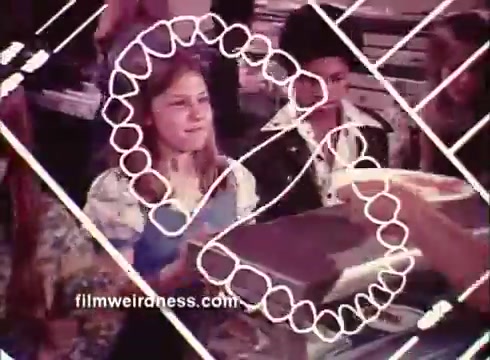 The still from the Colgate TV commercial features a group of children, with a particular focus on a girl with braces. The background is lively, suggesting a fun or engaging setting, likely aimed at kids. Overlaying the image is a graphic representation of teeth, emphasizing dental health. The commercial promotes Colgate's connection to oral care for children with braces.