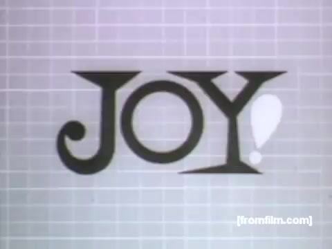 The still features the word 'JOY!' prominently displayed in a stylized font, set against a light-colored, grid-patterned background. The design reflects the playful and modern aesthetic typical of UPA animation in the 1950s, likely used to convey a sense of happiness and satisfaction related to Caloric Gas Appliances. The emphasis on the word is meant to evoke positive feelings about cooking and home life.