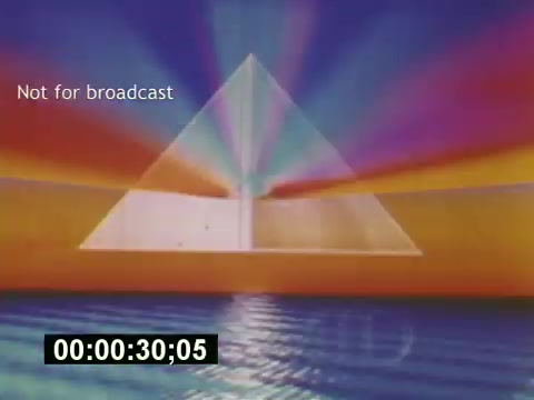 The still from 'Sixty Second Spot' features a vibrant, abstract background with rays of color radiating from a central pyramid shape. The design exudes a retro aesthetic typical of the mid-1970s, likely reflecting the style of television graphics from that era. The overlay text states 'Not for broadcast,' indicating it is intended for promotional or behind-the-scenes purposes rather than public airing. The timecode at the bottom suggests this still is from a specific moment in the film, which documents the entire process of creating a 7-Up commercial, from initial script development through to casting and filming.
