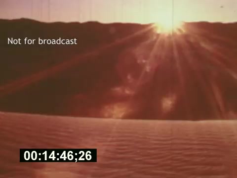 The still captures a vibrant sunset over a sandy landscape, conveying a sense of warmth and nostalgia. The text 'Not for broadcast' indicates the image is part of a behind-the-scenes look at the creation of a 7-Up commercial. The timestamp suggests this scene is part of the film 'Sixty Second Spot,' focusing on the creative process behind advertising in the mid-1970s.