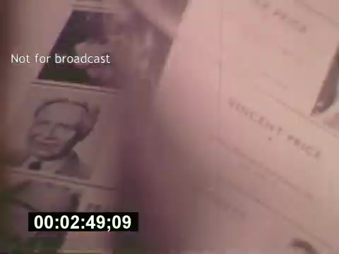 The still from 'Sixty Second Spot' showcases a moment during the creation of a 7-Up commercial from the mid-1970s. It features documents, likely involving casting or script details, with a focus on photographs of potential actors. The film traces the entire process from initial scripting to filming, providing a behind-the-scenes look at advertising production during that era. The timestamp indicates it's part of a segment detailing the early stages of the commercial's development.