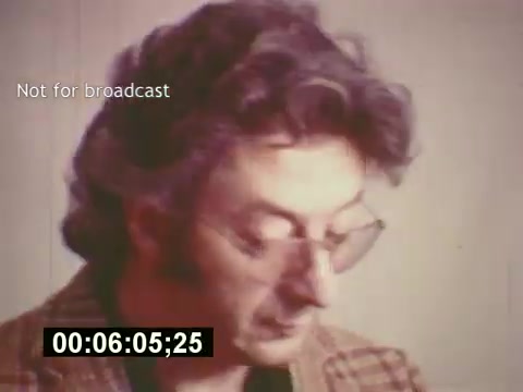 The still from 'Sixty Second Spot' captures a moment in the mid-1970s during the creation of a 7-Up commercial. It features a man, possibly a director or creative professional, focused on his work. His attire, typical of the era, and the warm color palette reflect the time period. This scene emphasizes the behind-the-scenes process of commercial production, highlighting the scripting, casting, and filming stages that lead to the final advertisement. The note 'Not for broadcast' suggests it's a private or instructional clip rather than promotional material.