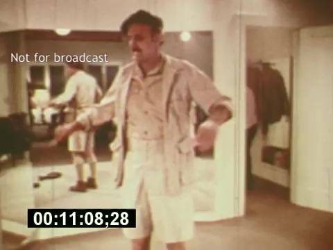 The still from 'Sixty Second Spot' features a man in a light-colored shorts and jacket outfit, appearing in a mirror while preparing for a scene. The setting suggests a dressing room or backstage area, indicative of the behind-the-scenes aspect of creating a TV commercial. The overlay text 'Not for broadcast' indicates that this footage is not meant for public viewing. The timeframe shown suggests it is an early part of the film, depicting the process leading up to the actual commercial for 7-Up.