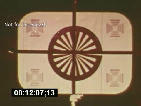 The still from 'Sixty Second Spot' features a test pattern, commonly used for broadcast calibration, with the text 'Not for broadcast.' The image likely signifies a moment of preparation or transition in the film, reflecting the behind-the-scenes process of creating a 7-Up commercial from scripting to filming. This film provides insight into the commercial production process from the mid-1970s.