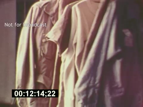 The still from 'Sixty Second Spot' features a close-up of hanging garments, likely costumes for the commercial being created. The image encapsulates a behind-the-scenes moment, illustrating the preparation and attention to detail involved in producing a 7-Up advertisement. The timestamp indicates it's a segment of the film focusing on the production process, emphasizing the craftsmanship that goes into commercial filmmaking from script to screen. The 'Not for broadcast' label suggests this is a private viewing, adding to its unique context.