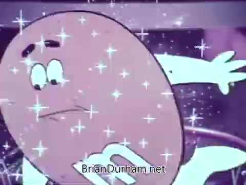 The still features an animated M&M's candy character, showcasing vibrant colors and sparkling effects, set against a basketball-themed backdrop. The character appears dynamic, likely in motion, with exaggerated expressions typical of animated commercials, emphasizing a playful and lighthearted tone.