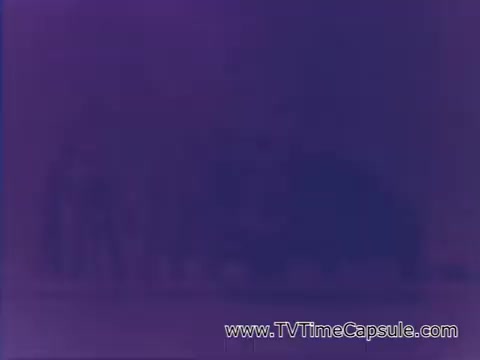 The still features a heavily color-altered or distorted image from the Coca-Cola advertisement 'Have a Coke and a Smile - Coke Adds Life.' It likely emphasizes themes of joy and refreshment associated with the brand, although specific details are obscured by the coloration.