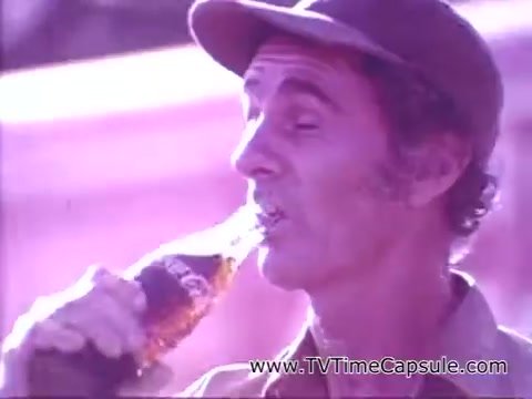 The still features a man enjoying a Coca-Cola beverage, capturing a moment of refreshment and satisfaction. He is wearing a hat and has a relaxed expression, showcasing the joyful sentiment associated with the slogan 'Have a Coke and a Smile.' The overall tone of the image conveys a sense of happiness and simple pleasures, central to Coca-Cola's marketing message.