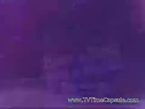 The still from the 'Have a Coke and a Smile - Coke Adds Life' commercial features a vibrant, colorful scene, likely emphasizing joyful moments and the enjoyment of Coke. The imagery typically promotes a sense of happiness and togetherness associated with sharing a Coke. The context suggests a nostalgic view of the brand's marketing strategy during that era, highlighting feelings of positivity and refreshment.