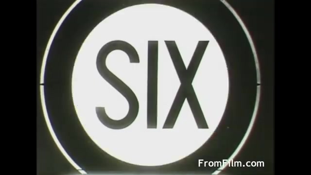 The still features a large circular graphic displaying the word 'SIX' prominently in the center. The design is characterized by bold letters against a white background, framed within a black circle. This visual style reflects the mid-20th-century graphic design aesthetic typical of advertisement. The context suggests it's from a commercial for Tang produced by UPA in 1958.