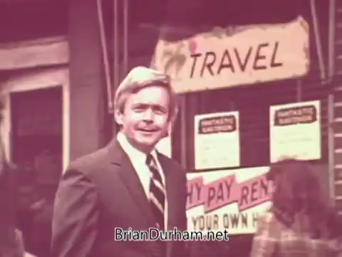 The still features a man in a suit standing outside a storefront with a sign that says 'TRAVEL.' Various notices are visible in the background, including one about renting. The overall tone suggests a promotional public service announcement focused on job opportunities and services in Ohio, likely emphasizing travel-related employment options.