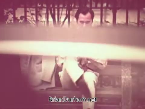 The still from the 'Job Service Ohio PSA' features a man sitting on a bench, holding a newspaper. He appears to be focused or contemplative, possibly reflecting on job opportunities. The image is framed to include a sense of privacy or separation, hinting at the themes of unemployment and job searching. The overall tone may evoke feelings of concern or introspection related to employment.