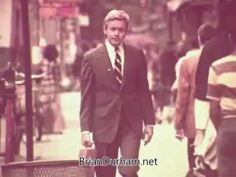 The still from the 'Job Service Ohio PSA' features a man in a suit walking confidently down a busy street. The setting appears urban, with people visible in the background going about their day. The overall tone suggests a focus on professionalism and opportunities in the job market.