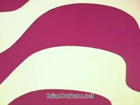 The still features a vibrant and abstract design with bold, wavy shapes in red and pink tones against a light background. The composition conveys a playful and dynamic visual style, typical of promotional material aimed at attracting attention. It likely serves to represent the theme of job services in Ohio, enhancing the message's engagement through eye-catching graphics. The URL 'BrianDurham.net' appears at the bottom, possibly indicating the source or creator of the content.