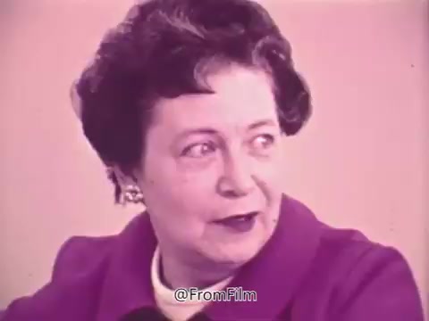 The still from the 1960s 'Prevent Blindness PSA' features a woman speaking about her experience with vision issues, expressing concern over her frequent need for new glasses. She reflects on how glaucoma was discovered during an eye exam following a physical examination but initially felt indifferent until she researched it later. The tone is informative and personal, aiming to raise awareness about eye health and the importance of regular eye exams.