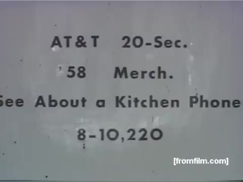 The still is a title card from a vintage 16mm animation commercial titled 'See About a Kitchen Phone,' produced in 1958 by UPA for AT&T. It features basic text detailing the commercial's duration (20 seconds) and note of its merchandise relevance. The understated design reflects the aesthetic of mid-20th century advertising.