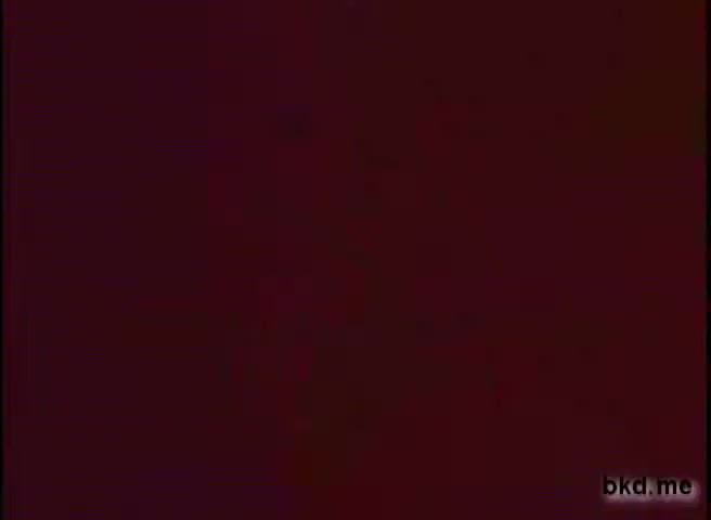 The still appears largely featureless and shows a reddish-brown tinted background, indicative of age and potential deterioration of a 16mm film print. It lacks distinct visual elements or identifiable subjects, typical of a transitional or blank frame in a film.