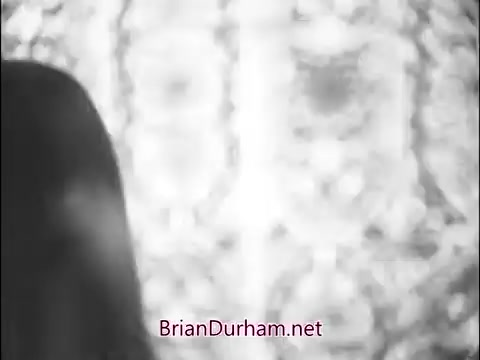 The 16mm still from the 1960s Girl Scout commercial likely portrays a girl or woman against a textured, possibly floral backdrop. The lighting and composition suggest a nostalgic, playful tone typical of the era, emphasizing community and camaraderie among Girl Scouts. The focus appears to be on promoting teamwork and companionship through the lens of Scouting activities.