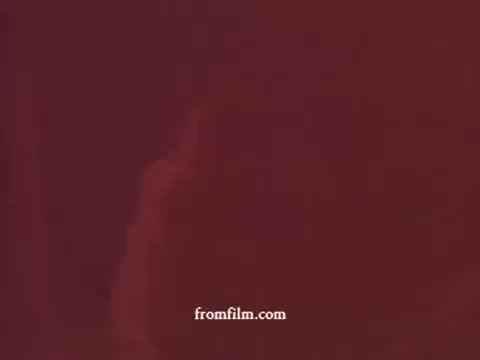 The still from the 1970s Tuna Helper commercial shows a deep red background, characteristic of the vintage film quality. The image may suggest a focus on the product or a related theme, reflecting the vibrant and energetic marketing style of the era. The simplicity of the visual composition conveys a straightforward promotional message, typical for food advertisements of that time.