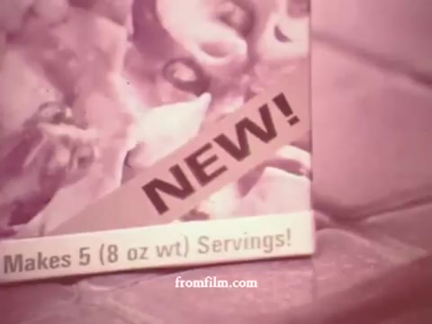 The still features a close-up of a Tuna Helper box from the 1970s, prominently displaying the word 'NEW!' in bold lettering. The box emphasizes that it makes '5 (8 oz wt) Servings!' The overall color tone has a vintage aesthetic typical of 16mm film from that era.