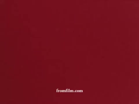 The still features a simple, solid red background, typical of promotional materials from the 1970s. It likely serves as a visually striking backdrop in the context of commercials for Airwick bathroom tablets, emphasizing cleanliness and freshness in a bathroom setting. The overall aesthetic is reflective of the era's advertising style, which often used bold colors and minimalistic design elements to convey messages effectively.
