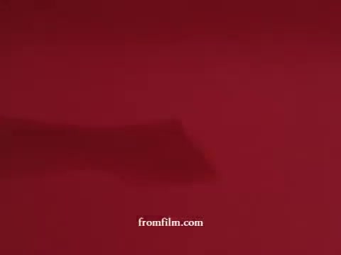 The 16mm still features a vividly red background, likely designating a focus on cleanliness and freshness, typical of 1970s bathroom product commercials. The shot captures a visual element related to Airwick bathroom tablets or a similar product, emphasizing its use in enhancing bathroom environments. The inclusion of Sani-flush imagery suggests a thematic connection to maintaining hygiene and an inviting atmosphere in restrooms. The overall aesthetic reflects the advertising style of that era, marked by bold colors and straightforward messaging.