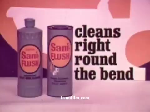 The still features two products from a 1970s Sani-Flush commercial, showcasing a bottle and a canister labeled 'Sani FLUSH.' The text prominently states 'cleans right round the bend,' highlighting the cleaning power of the product. The background is colorful and stylized, typical of the era's advertising aesthetics.