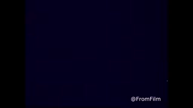 The still is from a 16mm print of a 1970s C&P Telephone commercial for Bell Telephone, featuring the tagline 'The next best thing to being there.' It likely highlights the communication services offered by C&P Telephone in West Virginia, showcasing the impact of telephony on connecting people. The post-1969 Bell System logo indicates its affiliation with the larger Bell network. The visual quality is consistent with period advertising, emphasizing the nostalgic charm of vintage commercials.